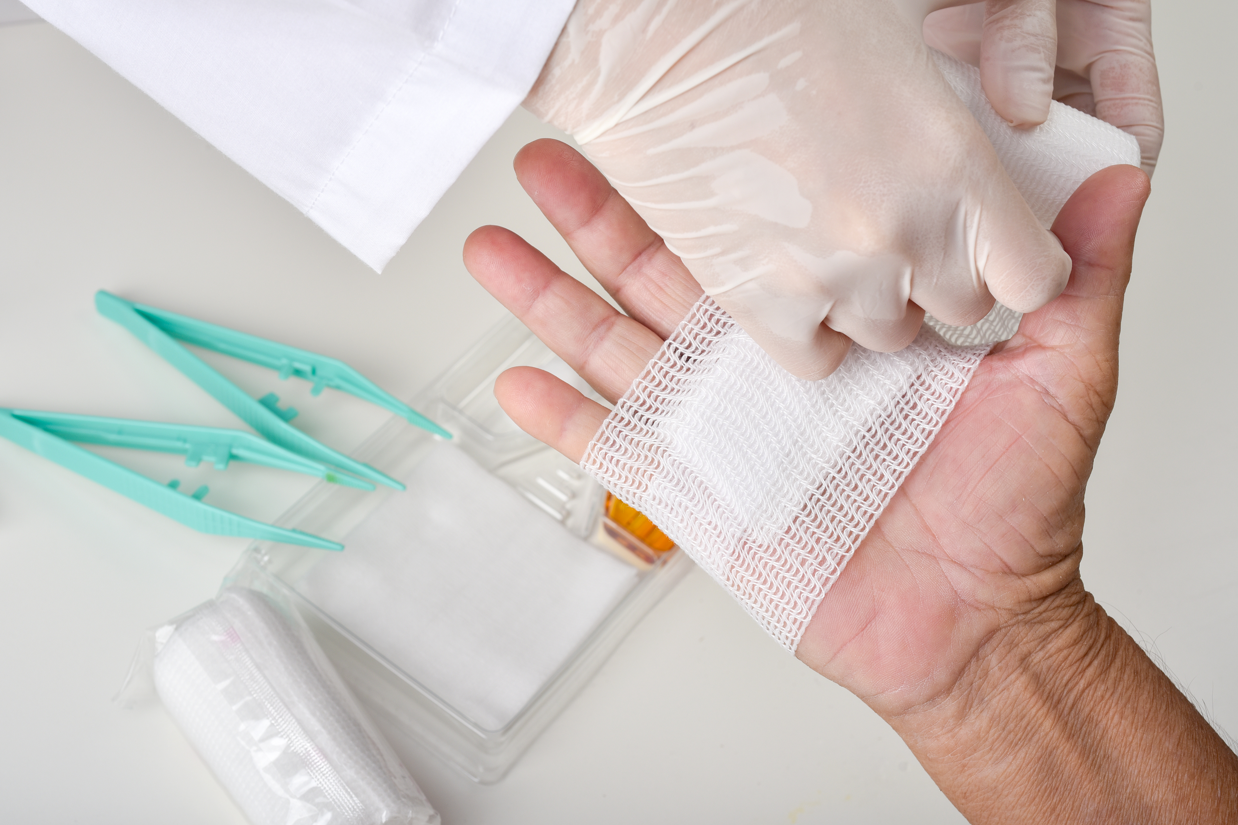 Clinician applying a wound care bandage