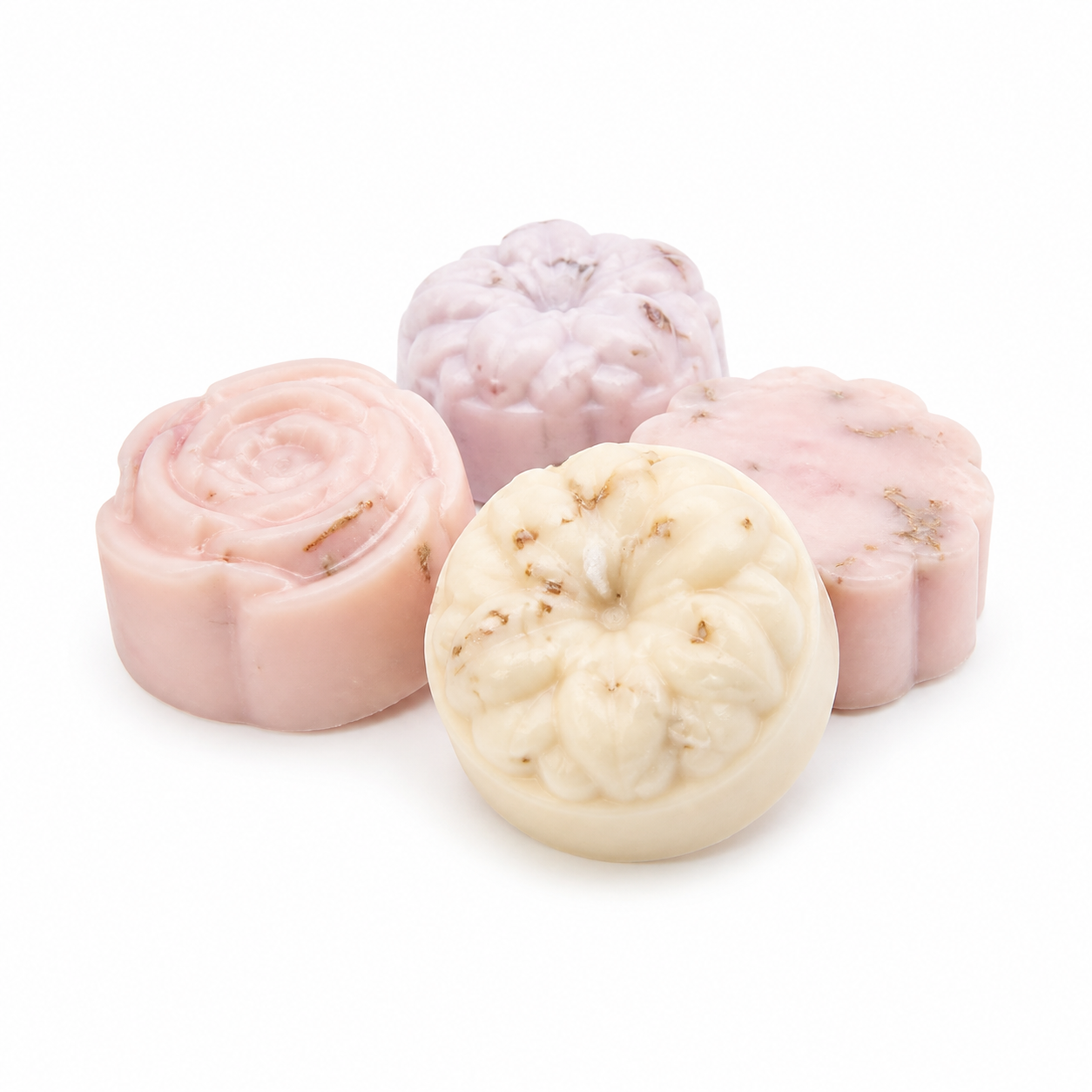 Cream, blush, and pale lavender handcrafted floral bar soaps on a white background